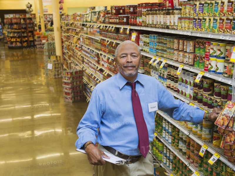 African American businessman smiling in grocery store