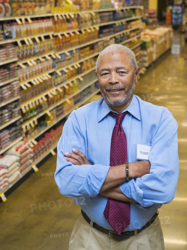 African American businessman smiling in grocery store