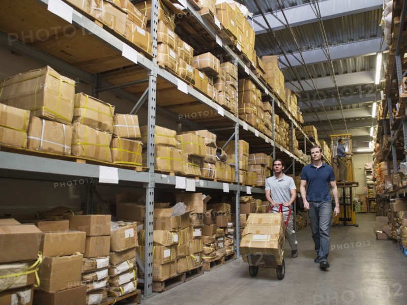 Workers carting boxes in textile factory