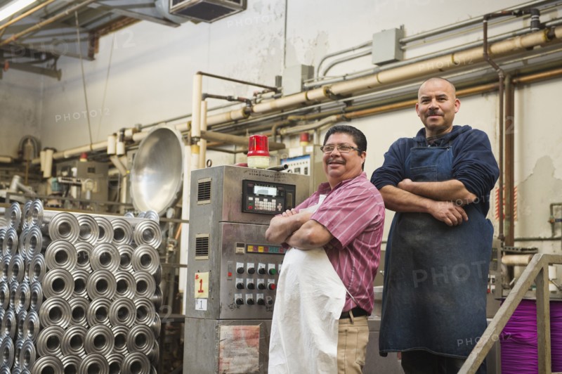 Hispanic workers smiling in textile factory