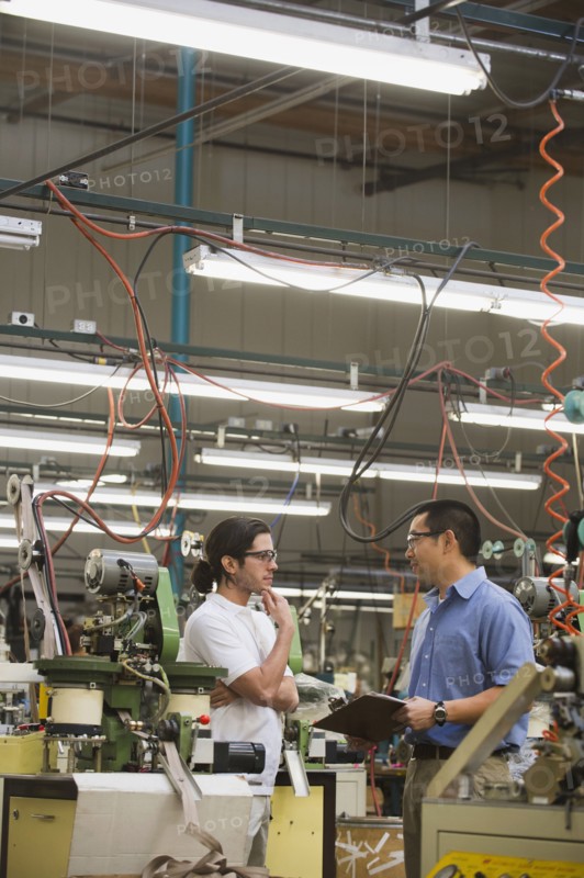 Workers talking in textile factory