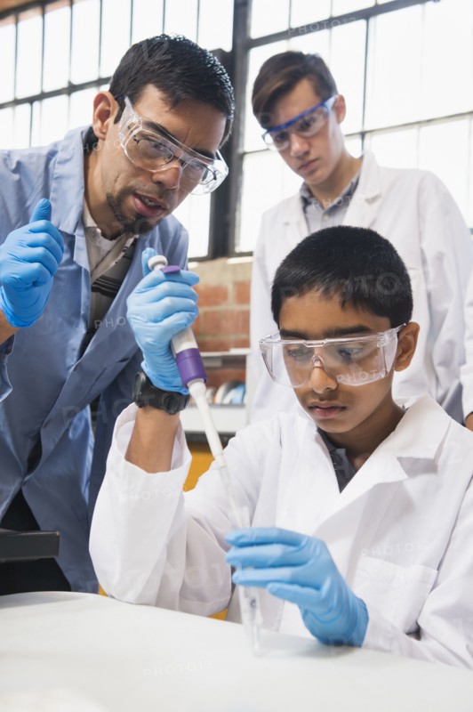 Teacher and students working in science lab