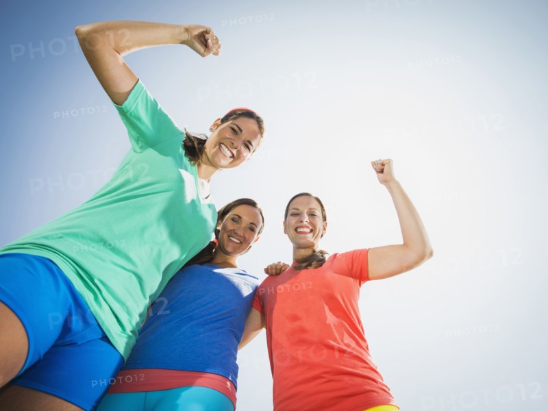 Caucasian women cheering outdoors