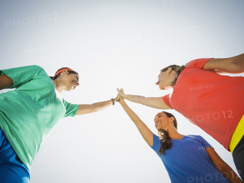 Caucasian women high fiving outdoors