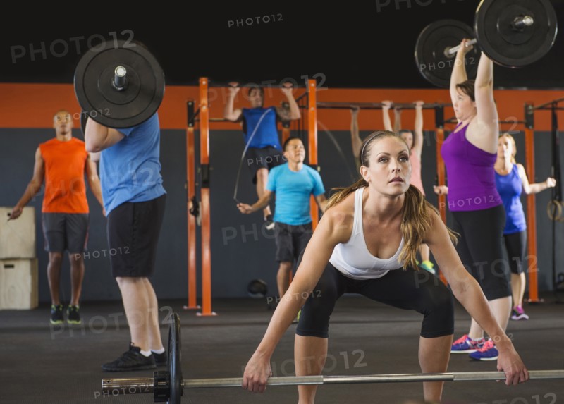 People lifting weights in gym