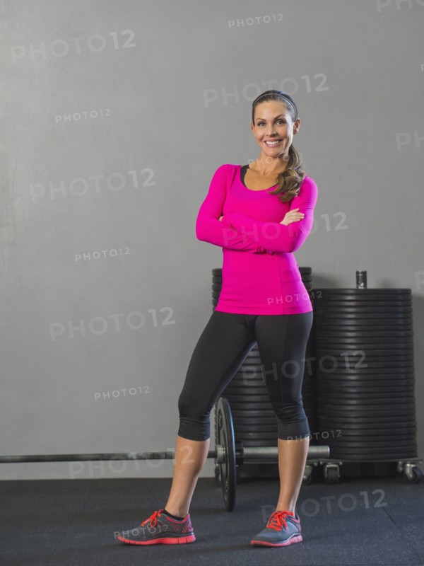 Caucasian woman smiling in gym