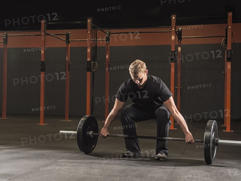 Caucasian man lifting weights in gym