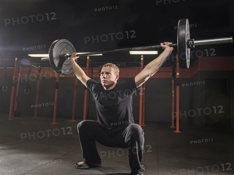 Caucasian man lifting weights in gym
