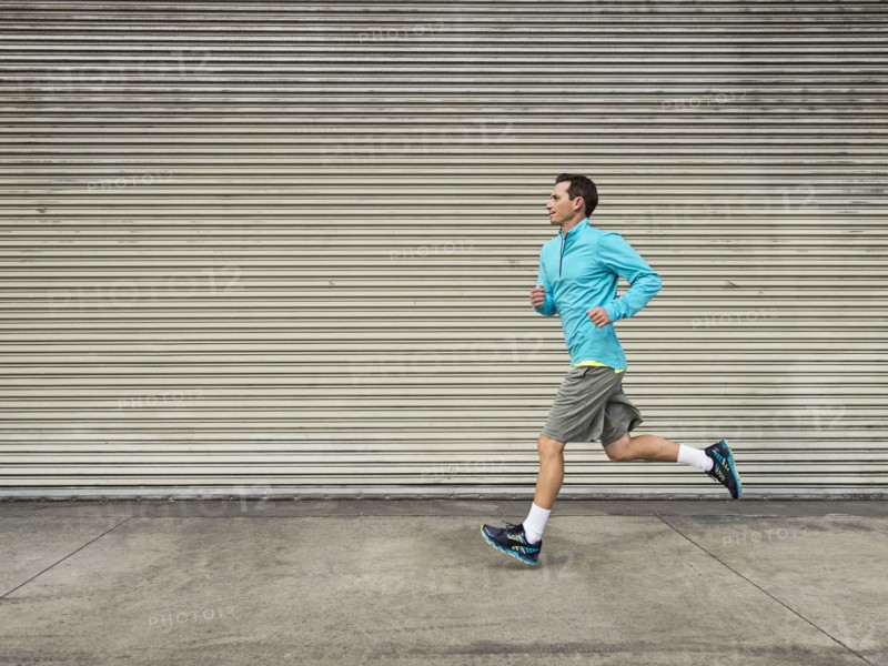Caucasian man running on city street