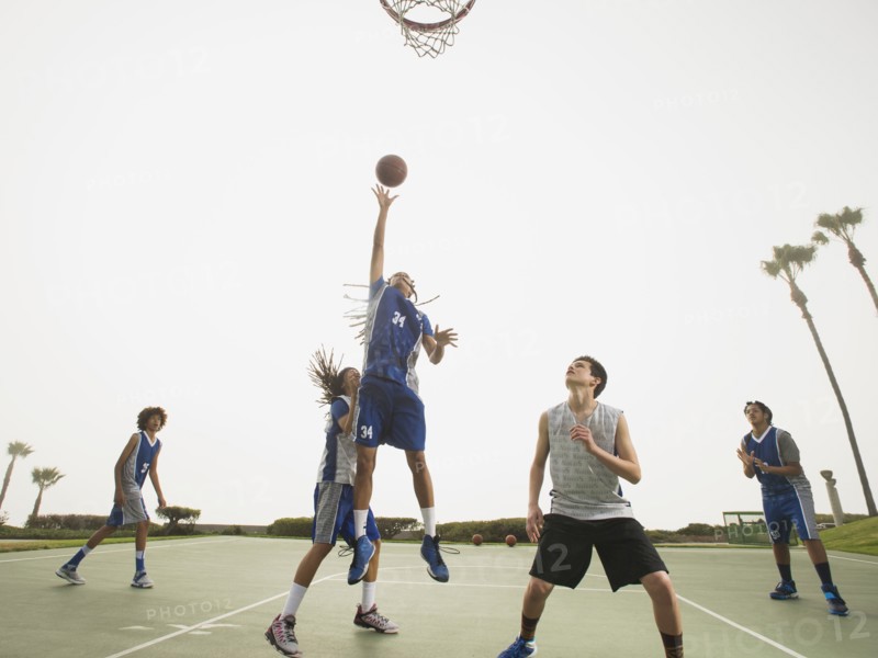 Basketball teams playing on court