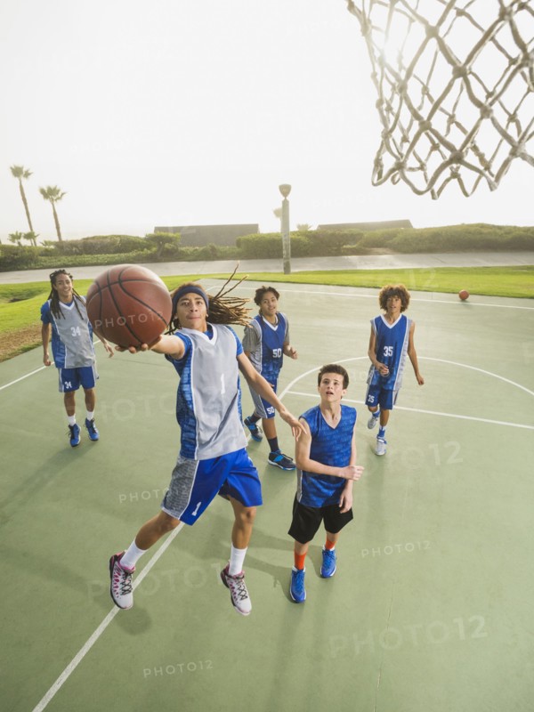 Basketball teams playing on court