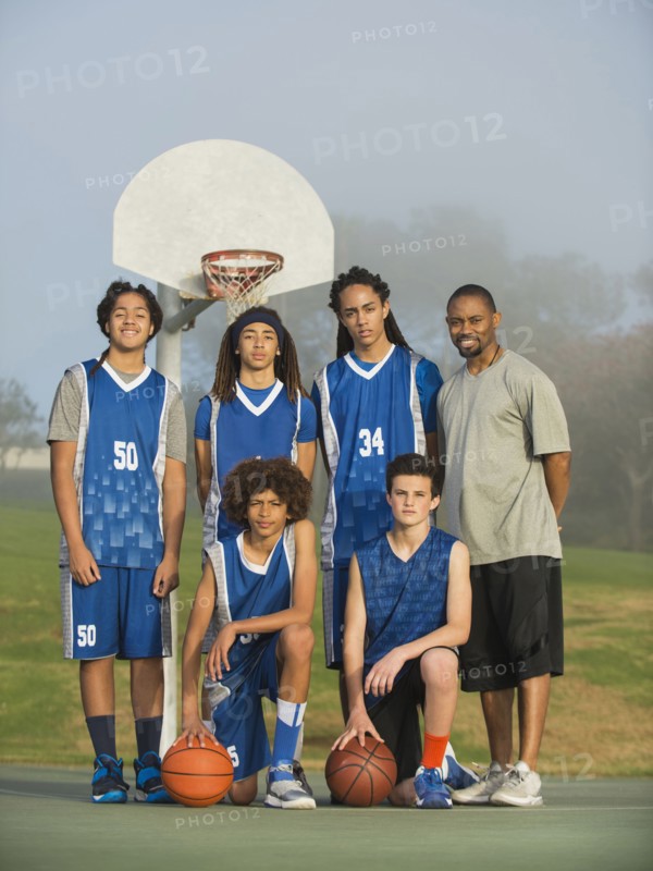 Basketball team posing on court