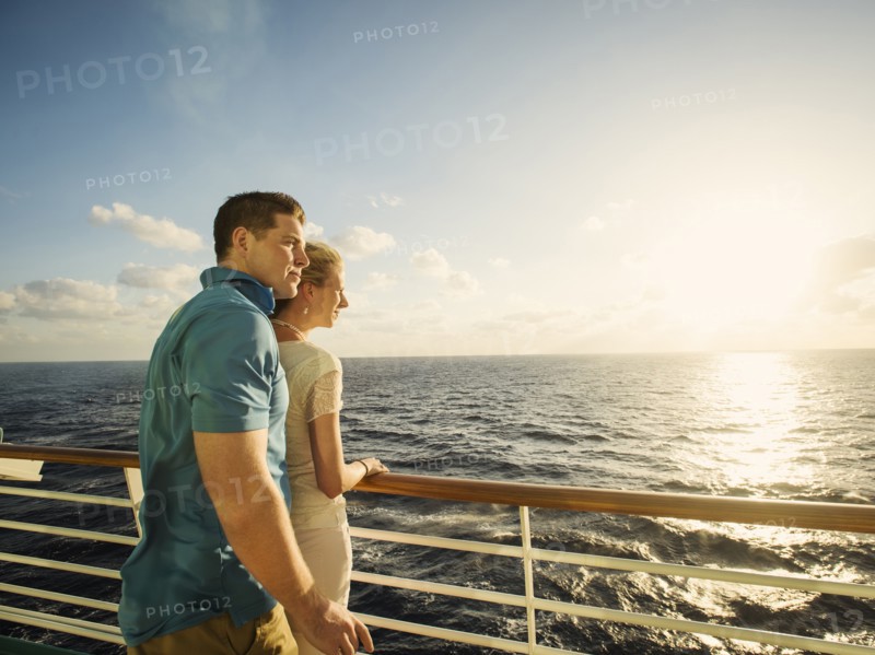 Caucasian couple admiring view from boat deck