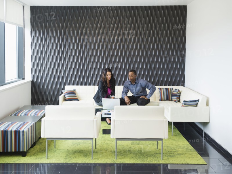 Business people talking in office lobby