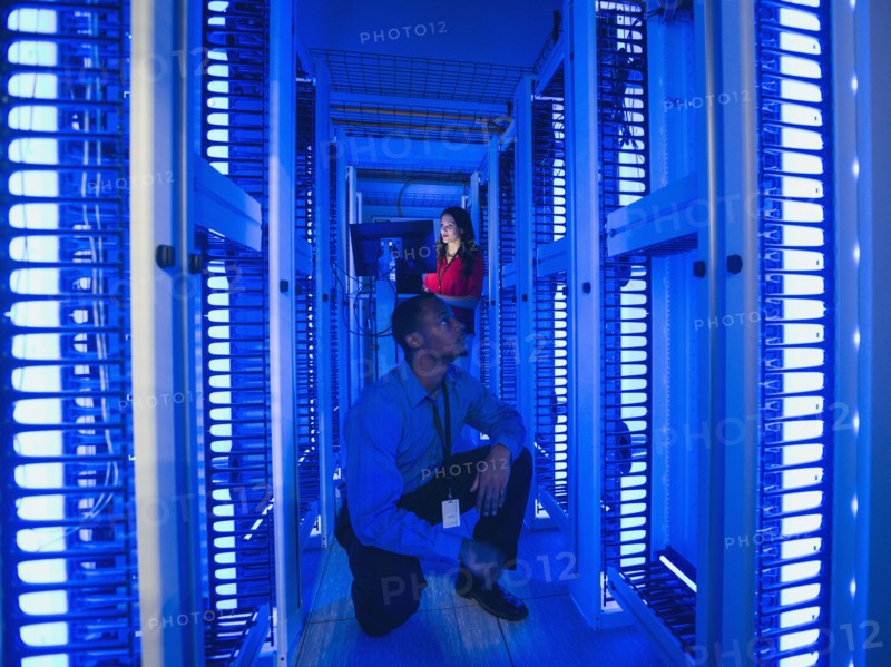Business people working in server room