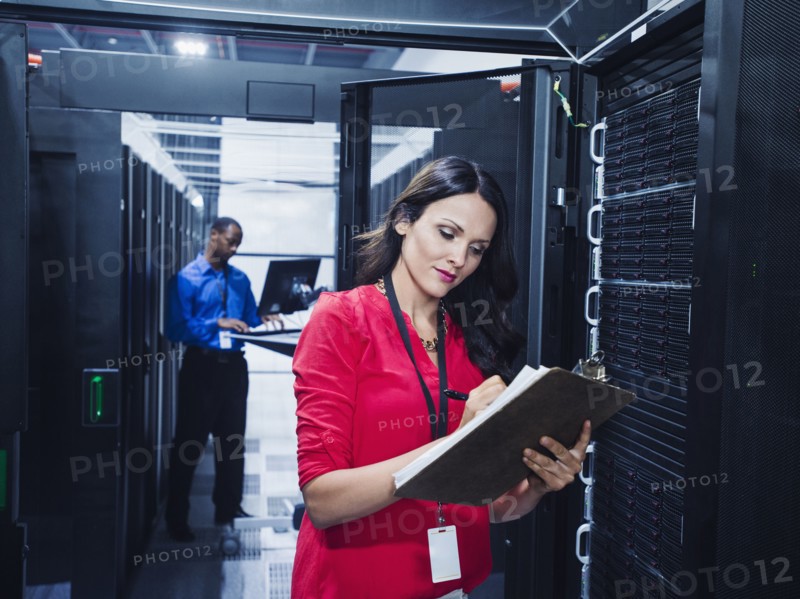 Business people working in server room