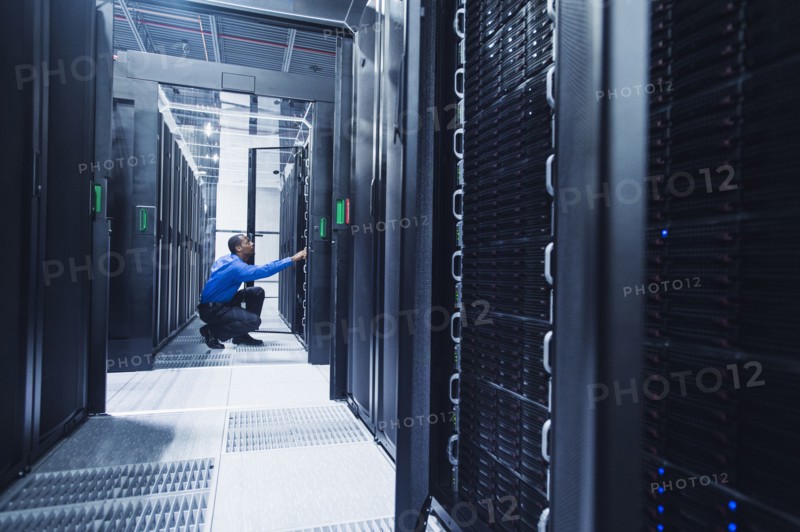 Black businessman working in server room