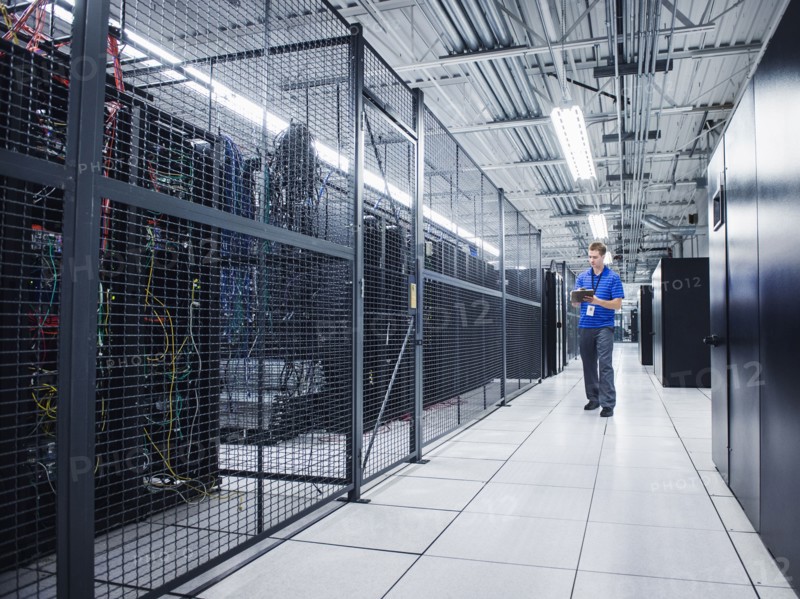 Caucasian technician using digital tablet in server room