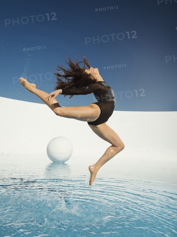 Caucasian woman dancing on water surface