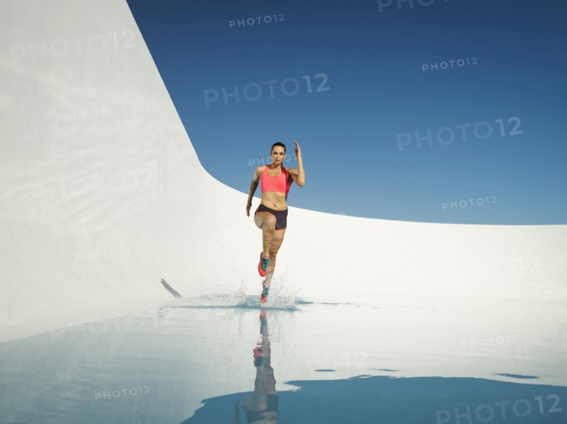 Caucasian woman running on water surface