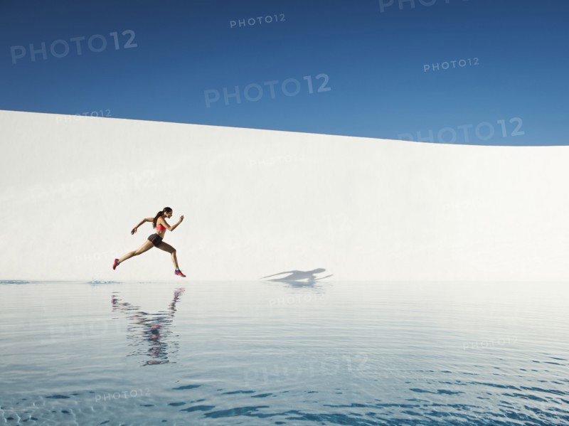 Caucasian woman running on water surface
