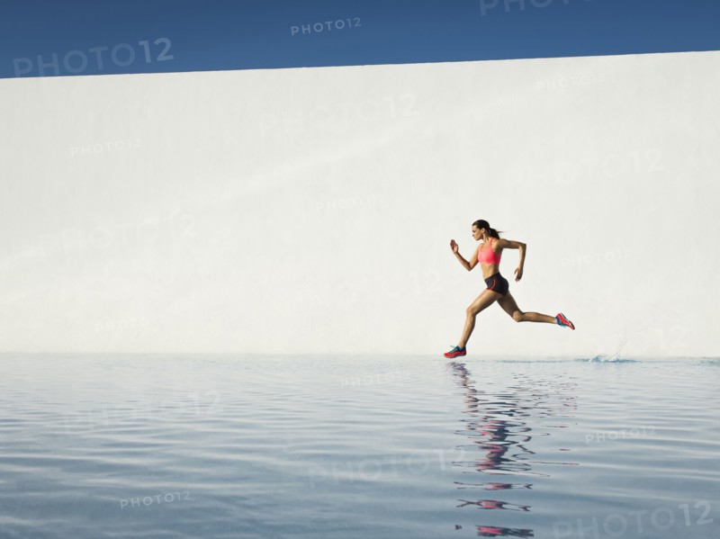 Caucasian woman running on water surface