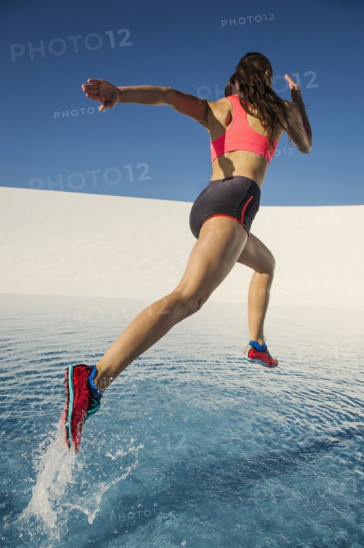 Caucasian woman running on water surface
