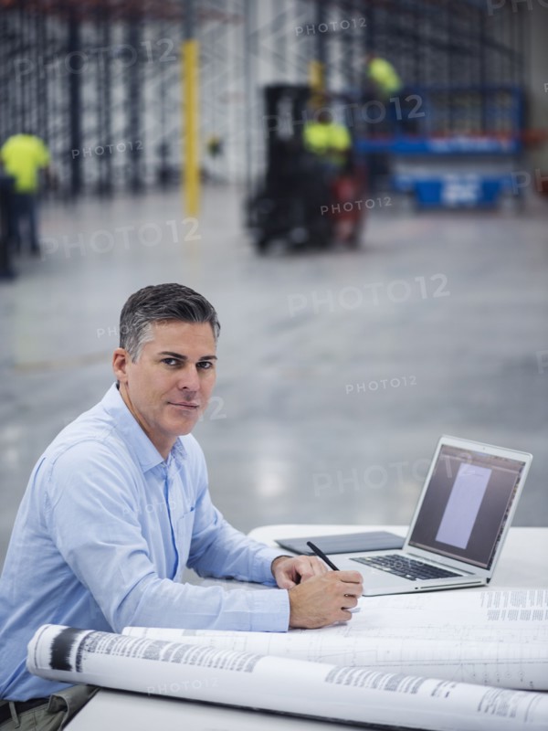 Caucasian architect working in warehouse