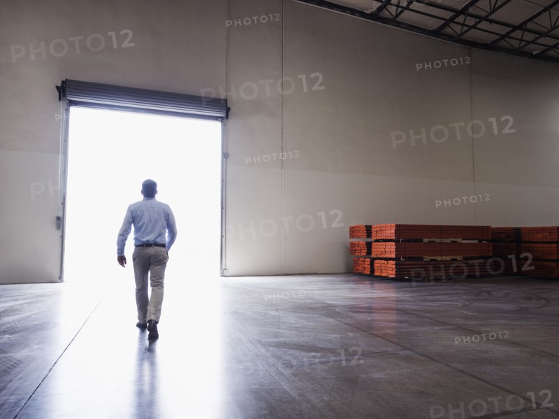 Caucasian businessman walking in warehouse