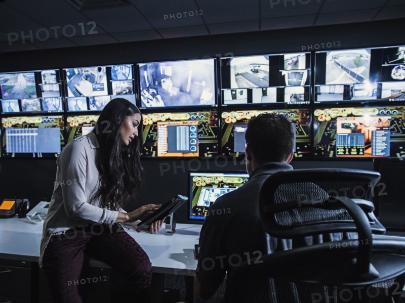 Security guards watching monitors in control room
