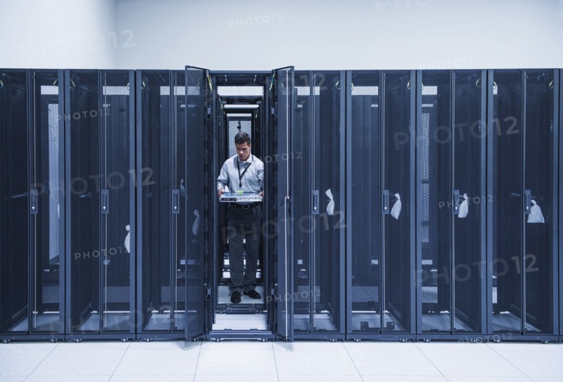 Hispanic technician working in server room