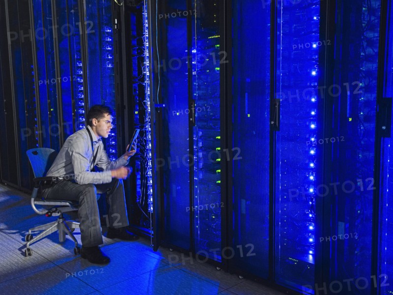 Hispanic technician working in server room