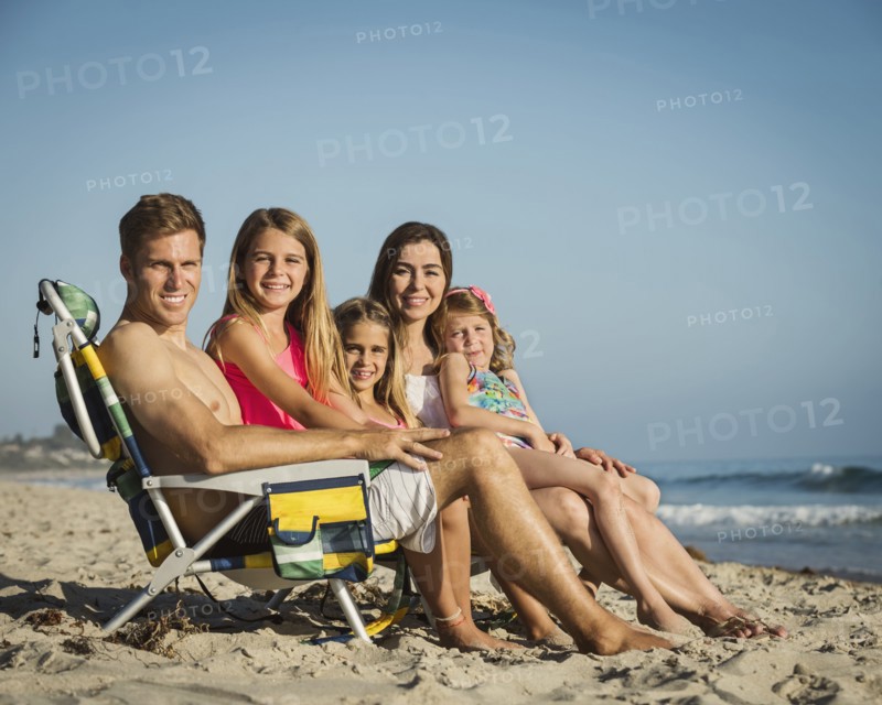Caucasian family smiling on beach