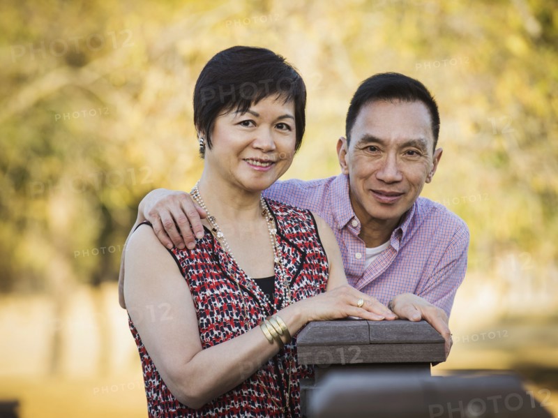 Older Chinese couple smiling outdoors