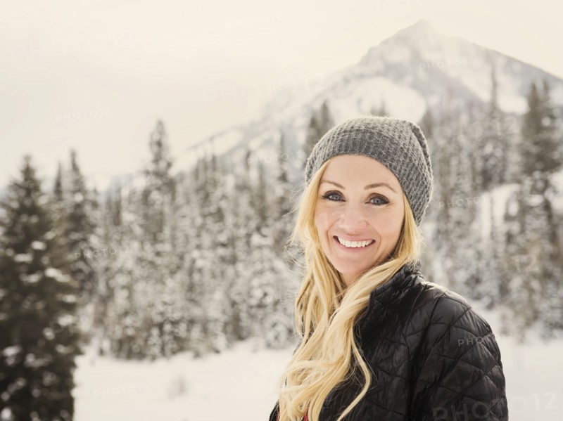 Caucasian woman smiling in snow