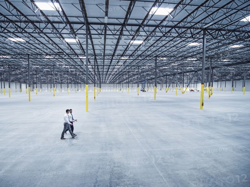 Businessmen walking in empty warehouse