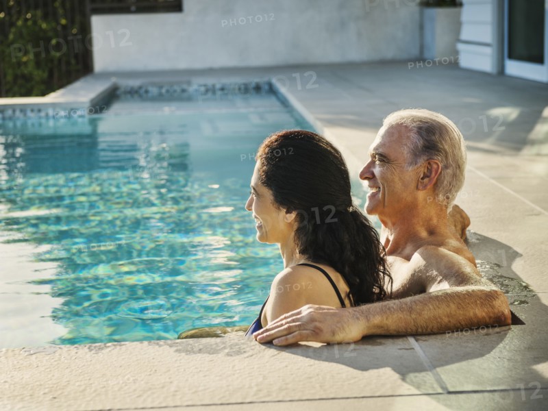 Older couple relaxing in swimming pool