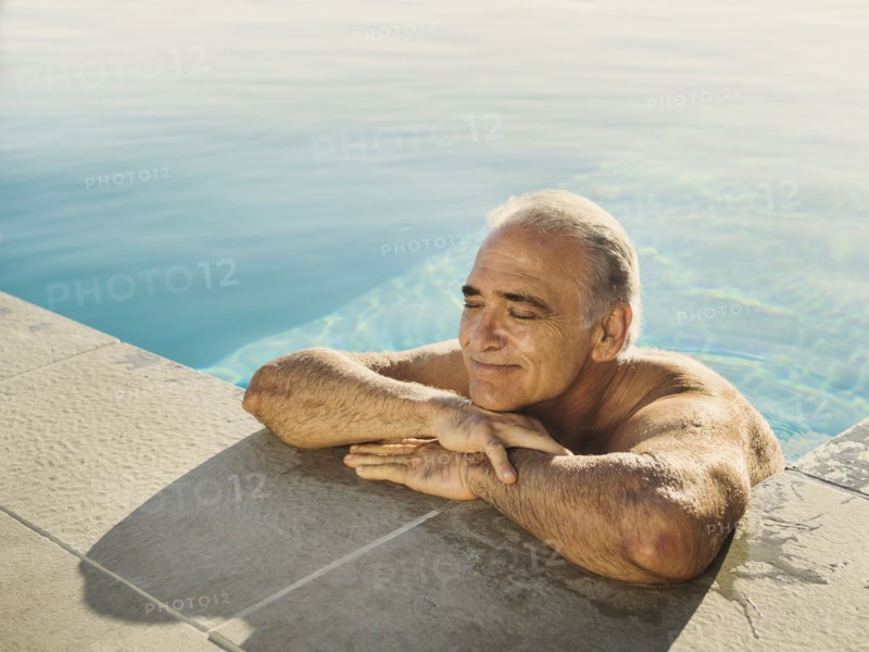 Portrait of Caucasian man relaxing in swimming pool