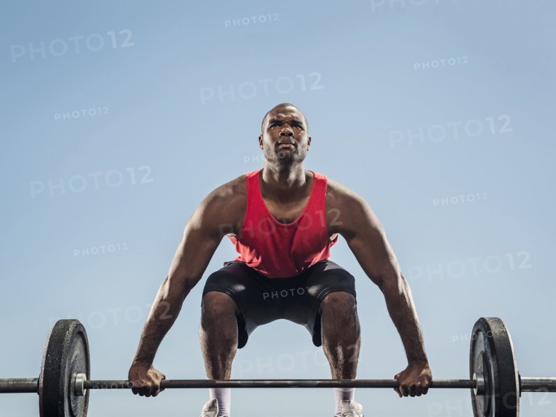 Black man preparing for lifting barbell
