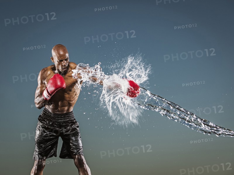 Water splashing on black boxer punching