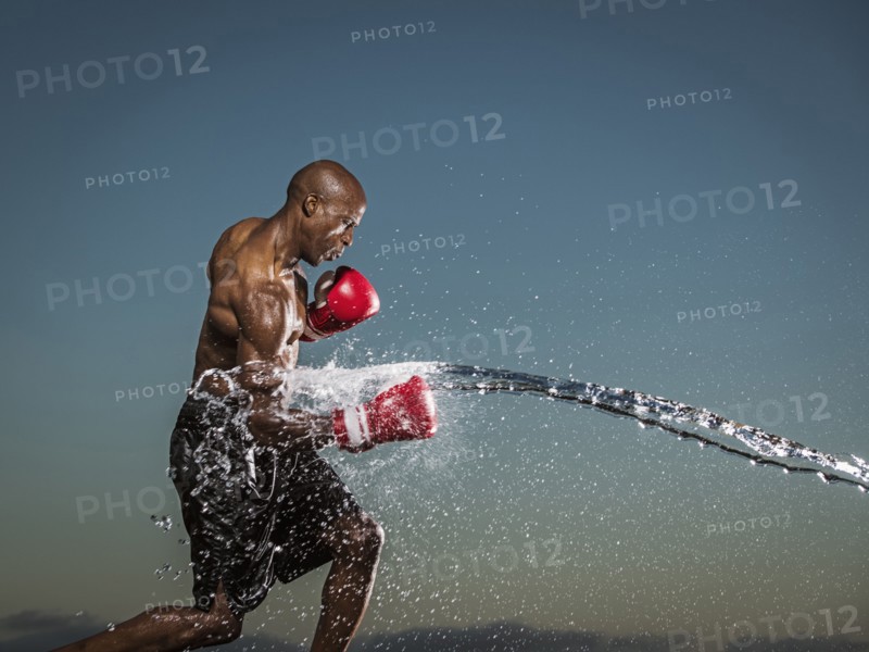 Water splashing on black boxer punching