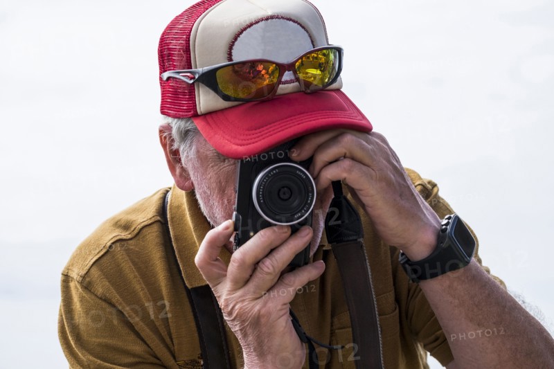 Caucasian man photographing with camera