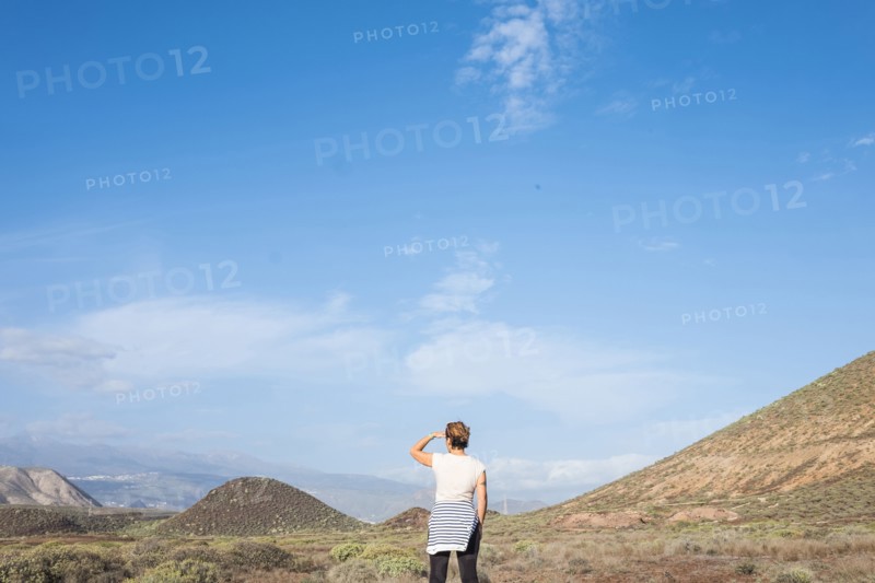 Caucasian woman admiring scenic view of distant landscape