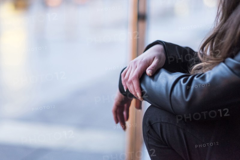 Midsection of Caucasian woman sitting outdoors