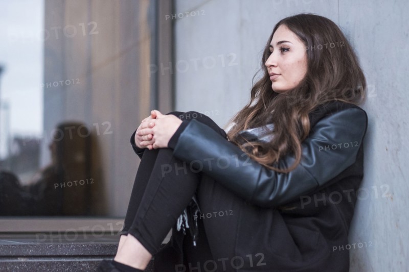 Pensive Caucasian woman sitting on staircase
