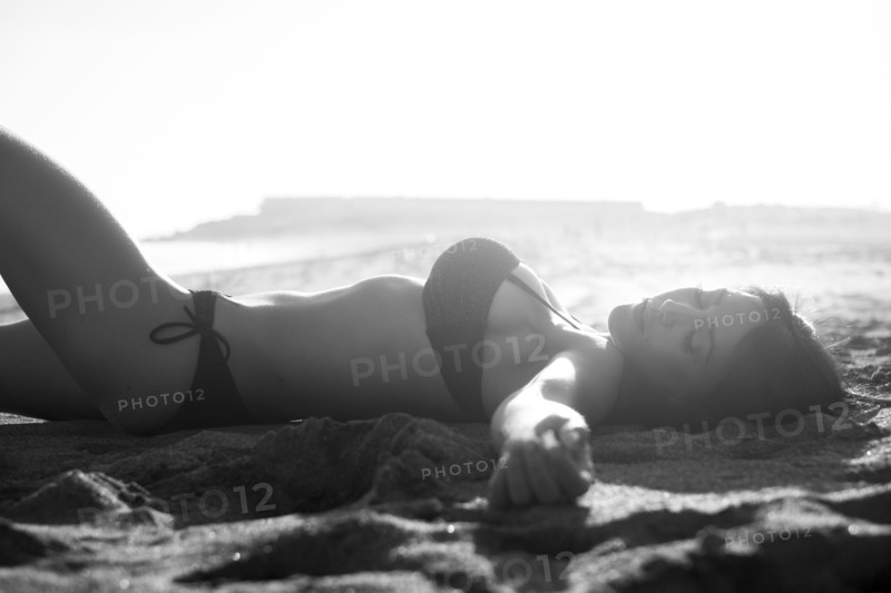 Caucasian woman sunbathing on beach