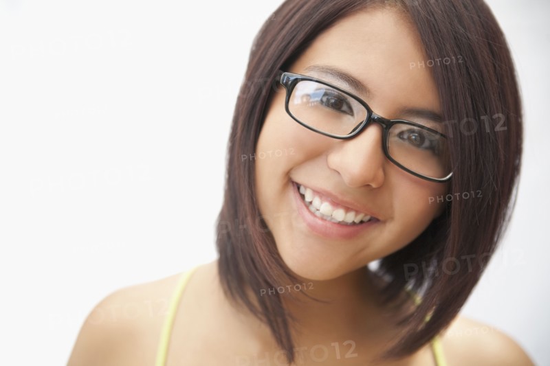 Hispanic teenage girl in eyeglasses smiling