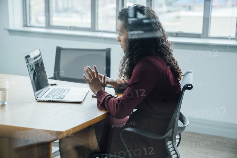 Mixed race businesswoman on video conference
