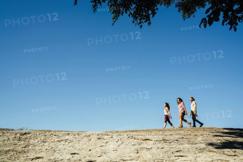 Friends walking under blue sky