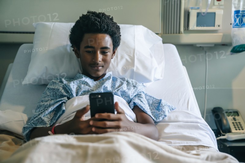 Blackboard texting on cell phone in hospital bed